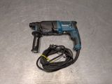 a cord connected to a drill on a metal surface