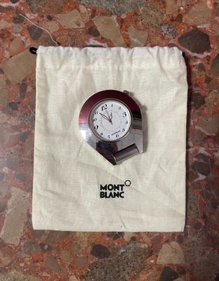a clock that is sitting on top of a bag