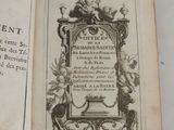 an old book that is open on a table