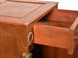 a small wooden desk with a drawer on top of it