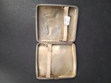 a small metal case with a piece of paper in it