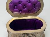 purple velvet covered box sitting on a white surface