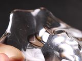 a person holding a crystal object in their hand