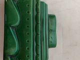 a close up of a green object on a white surface