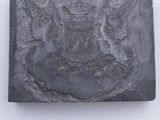 an image of a black soap bar on a white surface