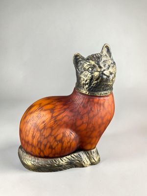 an orange and black cat figurine sitting on top of a white surface