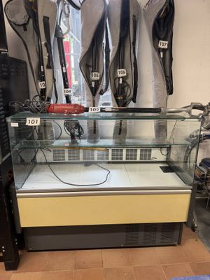 a glass display case in the middle of a room