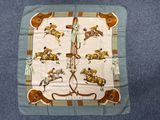 an image of a scarf with horses and jockeys on it