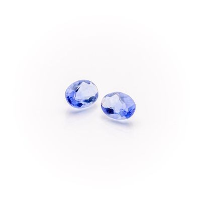 a pair of tanzanite gems on a white background