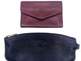 a close up of two different colored leather wallets on a white background