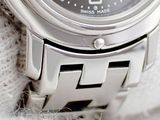 a close up of a wrist watch on a white cloth