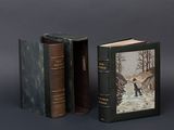two books are sitting next to each other on a gray surface