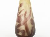a glass vase with a brown and white design on it