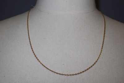 a close up of a mannequin torso with a chain on it