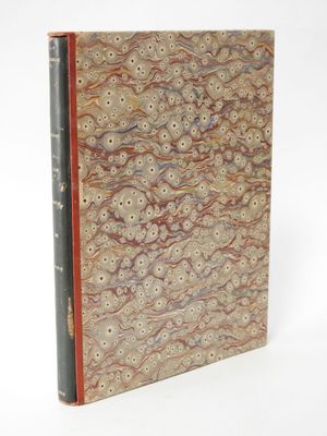 an old book with a brown cover and a red binding