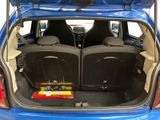 the back of a blue car with its trunk open and the back seats folded down