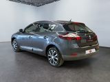 the back of a silver car in a room with a black floor
