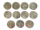 six different types of coins are shown on a white surface