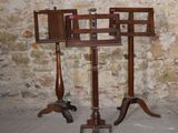 a wooden stand with a mirror on it in front of a brick wall