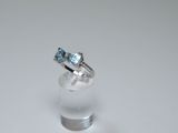 a picture of a ring with a blue topaz stone on it