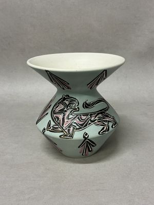 a small vase with a design on it on a table