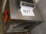 a stove with a sign on top of it in a kitchen