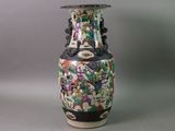 a vase with a floral design on it sitting on a table