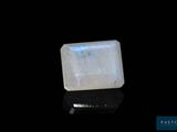 a white quartz stone on a black surface
