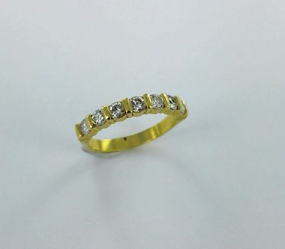 a yellow gold ring with five diamonds on a white background