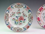 pair of chinese plates with floral designs on them on a white surface