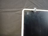 a laptop computer with a broken screen sitting on a table