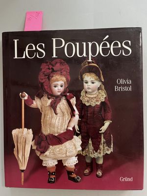books about dolls and dolls on display on a white wall