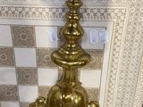 a gold toilet in a bathroom with a checkered floor