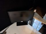 a computer monitor sitting on top of a desk
