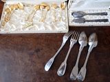silverware in a box on a table with other silverware