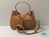 an image of a brown purse with a strap on it