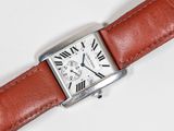 an image of a watch with roman numerals on a brown leather strap