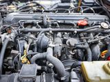 a close up of a car engine with its hood open