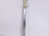 a close up of a sword on a white surface