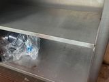a stainless steel counter with plastic bags on top of it
