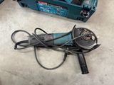 a corded drill and a corded cutter on the floor