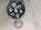 a black and white picture of a stove and a pink object on the floor