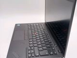 a laptop with a black keyboard sitting on a white surface