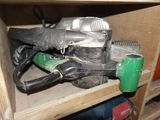 a picture of a cluttered cabinet with tools and a blow dryer