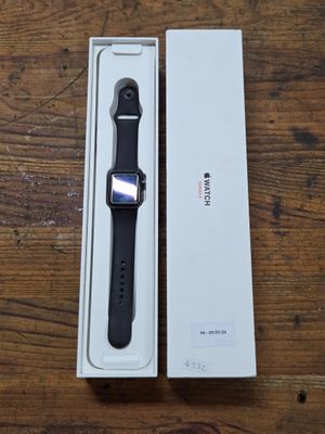 apple watch in box on wooden table with wooden table top