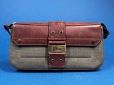 a brown and grey purse with a metal buckle on it