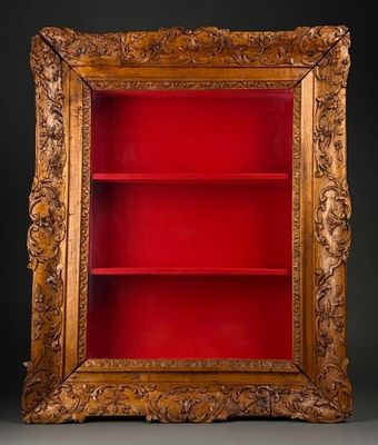 an antique wooden bookcase with a red book shelf in the middle