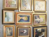 de nombreux tableaux encadrés accrochés au mur d'une pièce
