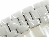 a close up of a watch bracelet on a white surface