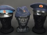 three mannequin heads with hats on each of them